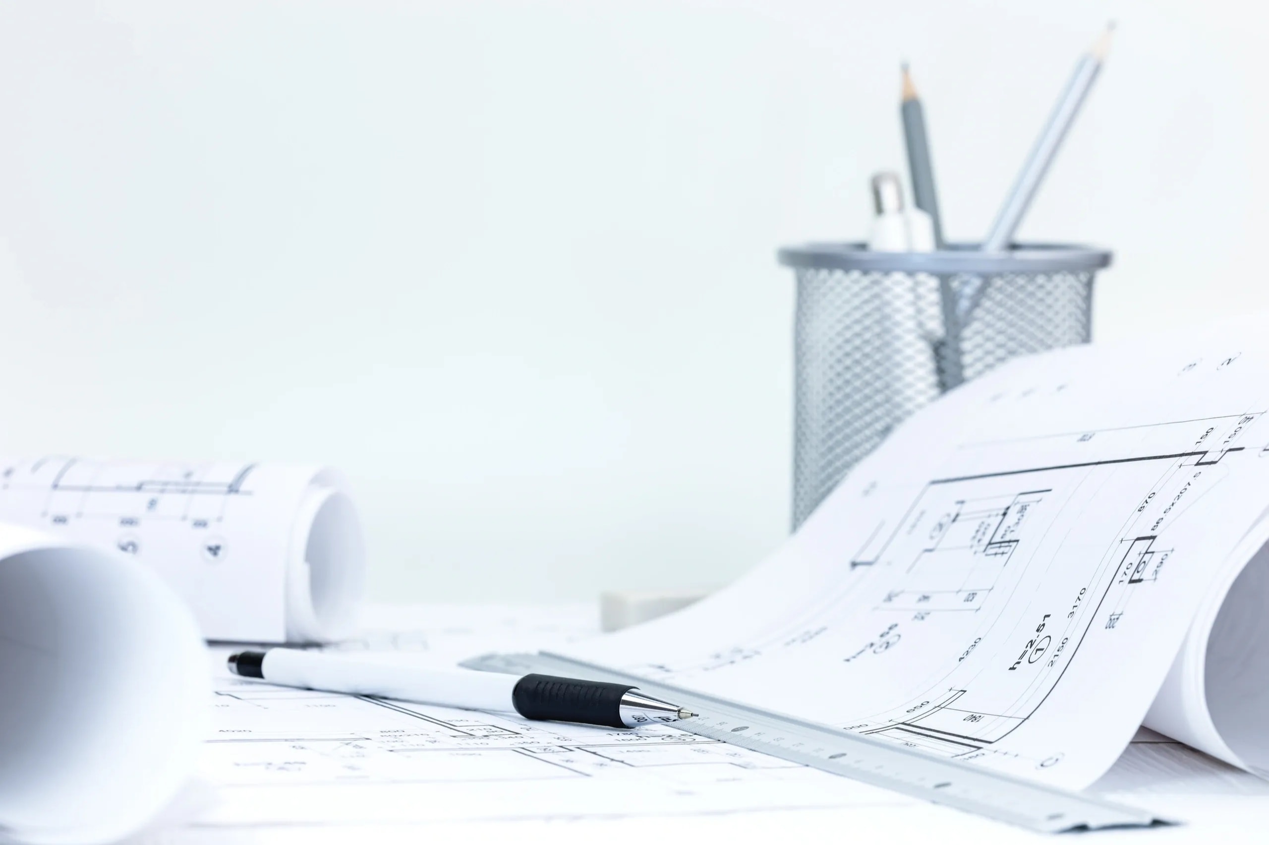 Rolled architectural blueprints and technical specification drawings